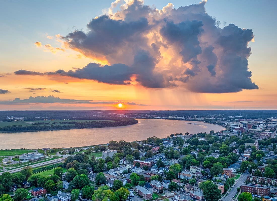 Evansville, in - Evansville, Indiana at Sunset Over the Residential Houses and a Local Lake Connecting the Community Together